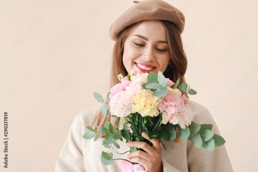 Beautiful young woman with bouquet of carnation flowers on light background Beautiful young woman with bouquet of carnation flowers on light background
