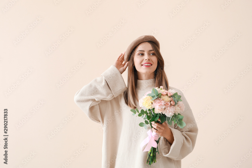 Beautiful young woman with bouquet of carnation flowers on light background Beautiful young woman with bouquet of carnation flowers on light background