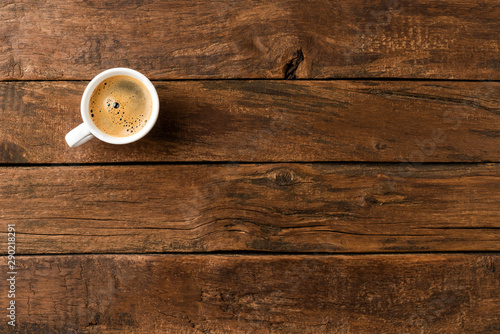 Coffee cup on vintage wooden table with copyspace. Top view