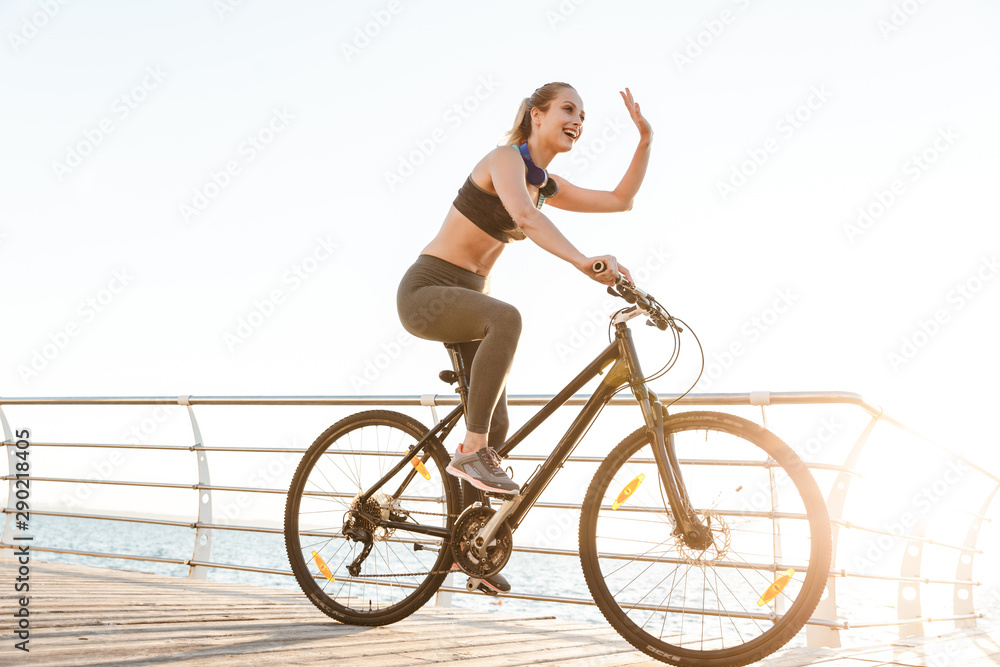 Fototapeta premium Beautiful young fitness woman cyclist wearing