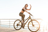 Beautiful young fitness woman cyclist wearing