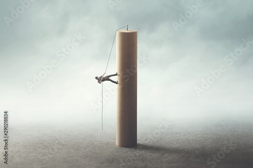 business man climbing the tower with a rope