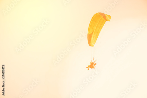 Extreme sports with paramotor. Flying high in the sky to see the evening scenery.