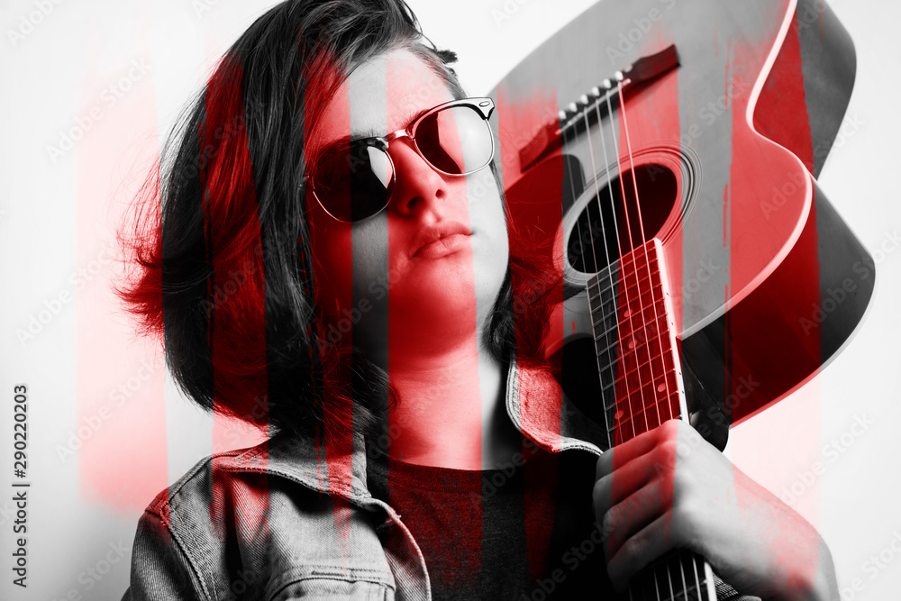Obraz premium Portrait of a teenager with guitar in studio.