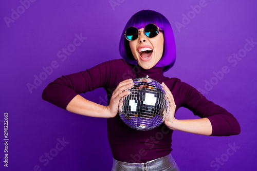 Portrait of wild millennial with eyeglasses eyewear screaming wearing turtleneck silver skirt isolated over purple violet background