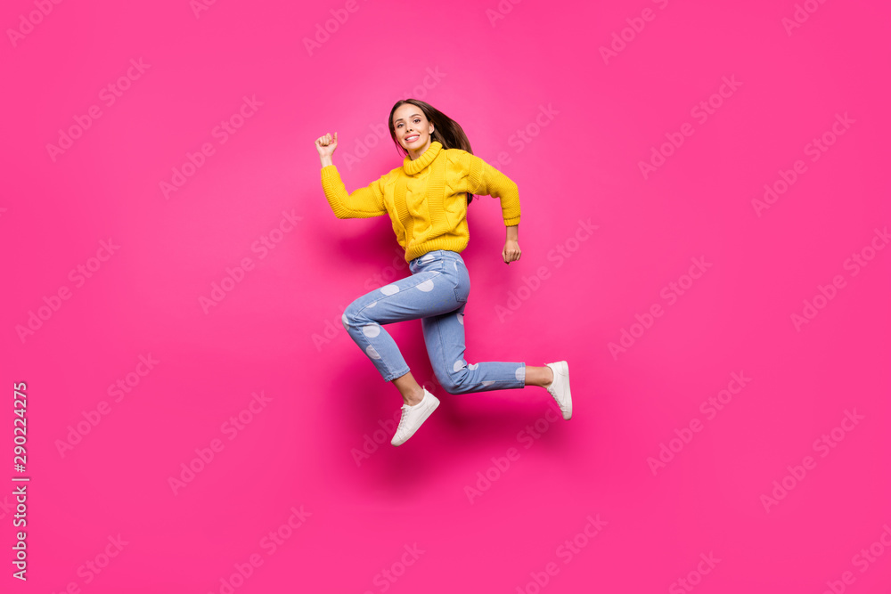 Full length photo of lovely girl jumping running wearing yellow pullover dotted denim jeans isolated over fuchsia background - obrazy, fototapety, plakaty 