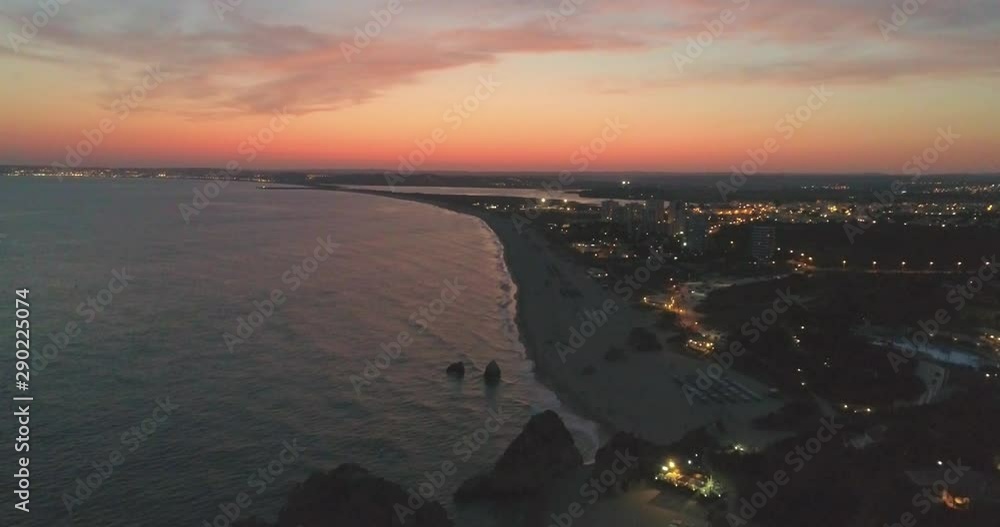 Aerial dusk view of Praia dos Tres Irmaos (Three Brothers beach) in Alvor, famous tourist destination in Western Algarve Coast, Portugal. Aerial dusk view of Praia dos Tres Irmaos (Three Brothers beach) in Alvor, famous tourist destination in Western Algarve Coast, Portugal.