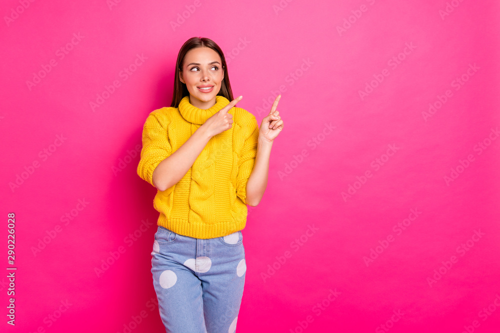 Portrait of nice lady showing adverts looking wearing yellow pullover isolated over fuchsia background Portrait of nice lady showing adverts looking wearing yellow pullover isolated over fuchsia background