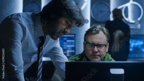 Government Chief of Cyber Security Agent Consults Military Officer who Works on Computer. Specialists Working on Computers in System Control Room.