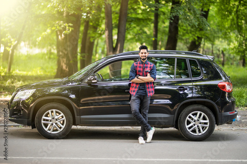 Young handsome indian man standing near his car on the road © F8  \ Suport Ukraine