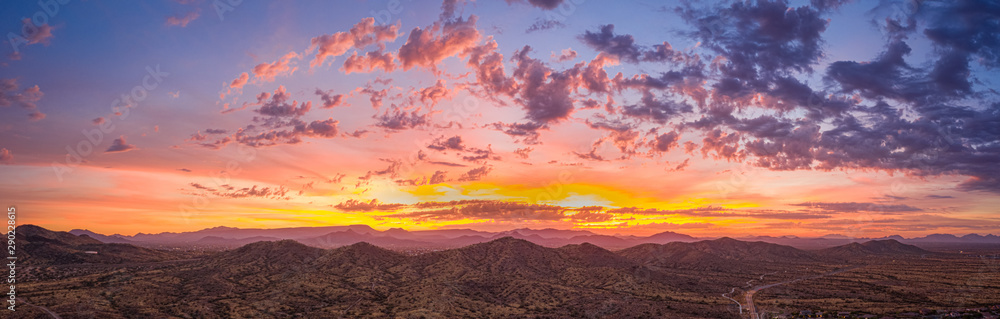 Sunrise panorama over the sonoran desert of Arizona with layers of mountains shot at altitude by a drone.