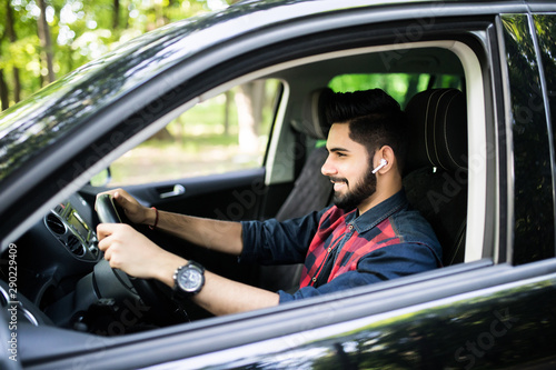 A handsome Indian man drive car on the street road