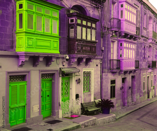 Fototapeta Naklejka Na Ścianę i Meble -  Purple street with green doors and balconies