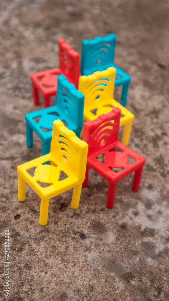 Multi-colored chairs on a concrete floor