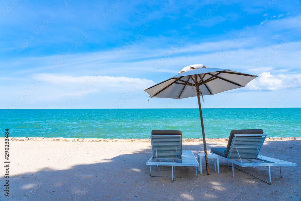 Beautiful umbrella and chair around beach sea ocean with blue sky for travel