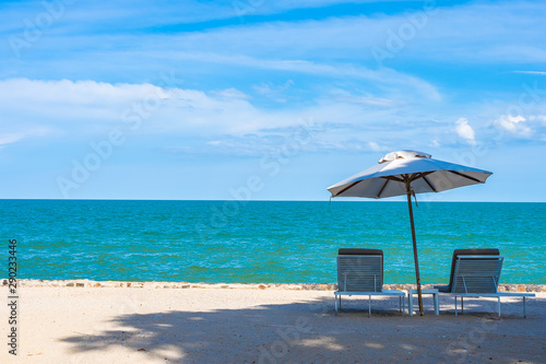 Beautiful umbrella and chair around beach sea ocean with blue sky for travel