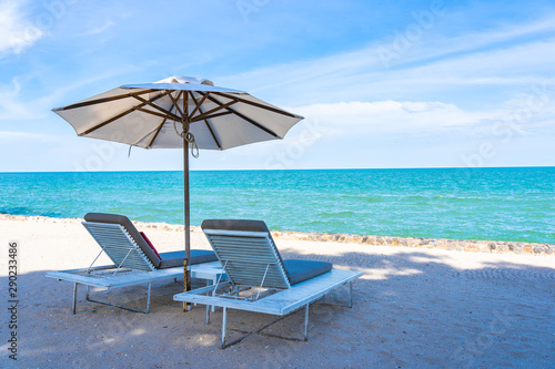 Fototapeta Naklejka Na Ścianę i Meble -  Beautiful umbrella and chair around beach sea ocean with blue sky for travel