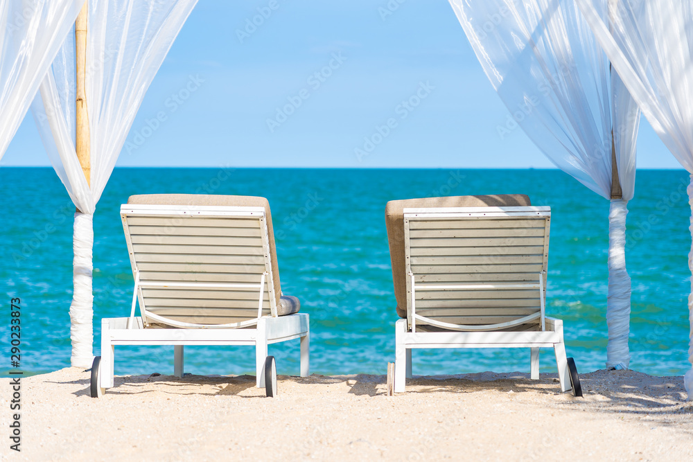 Obraz premium Beautiful umbrella and chair around beach sea ocean with blue sky for travel