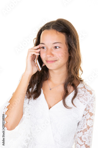 Beautiful young girl looking aside talking on the phone in white Studio isolated background