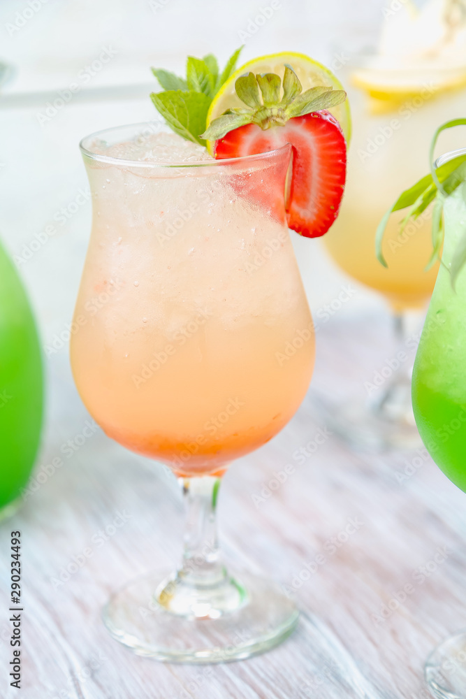 A variety of soft drinks. Assortment of soft drinks. Tarragon lemonade, Strawberry lemonade, Pear lemonade. Lemonade on a light background.