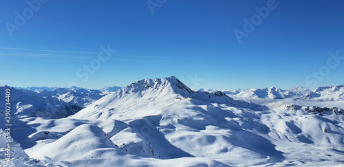 beautiful view alpine french snowy peak mountain under blue sky © coco