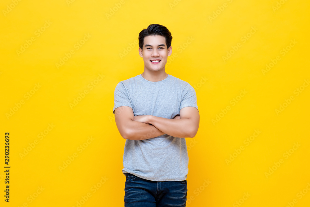 Handsome man standing with crossed arms gesture - obrazy, fototapety, plakaty 
