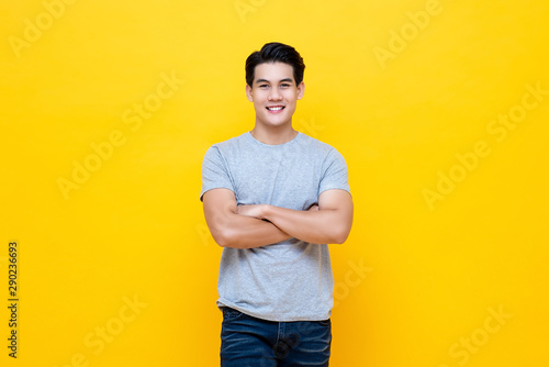 Handsome man standing with crossed arms gesture