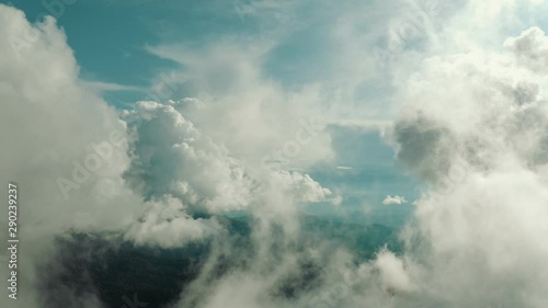 The flight in beautiful clouds above mountains
