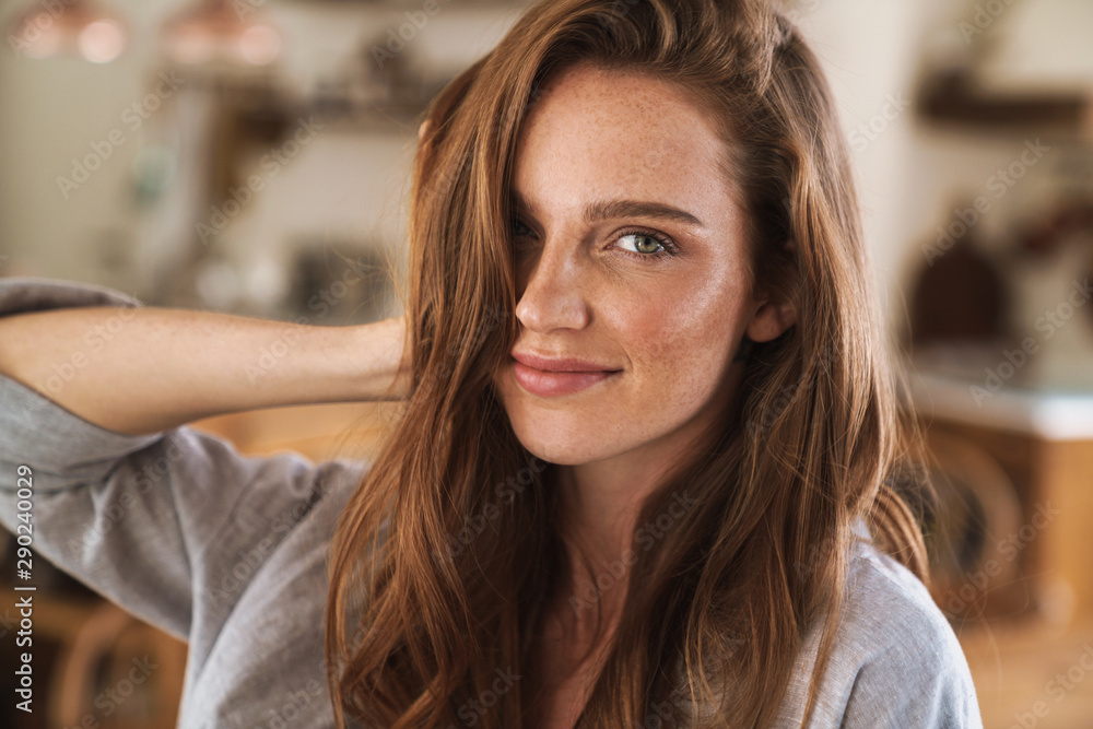 Fototapeta premium Optimistic happy pleased redhead woman indoors at home.