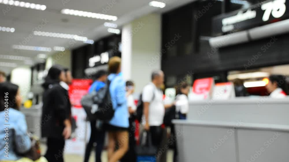Out of focus unidentified people are waiting in line to get a plane ticket check. From airline staff and walked onto the plane to go to the destination. Out of focus unidentified people are waiting in line to get a plane ticket check. From airline staff and walked onto the plane to go to the destination.