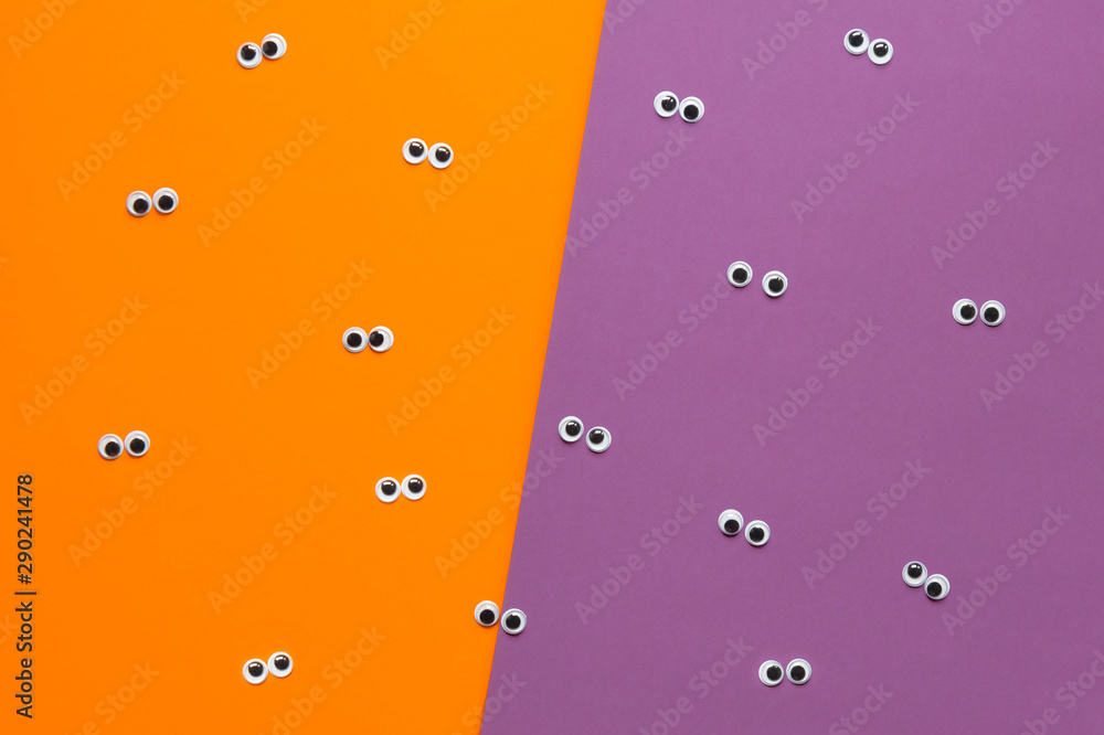 Halloween googly eyes color block orange and purple background Stock