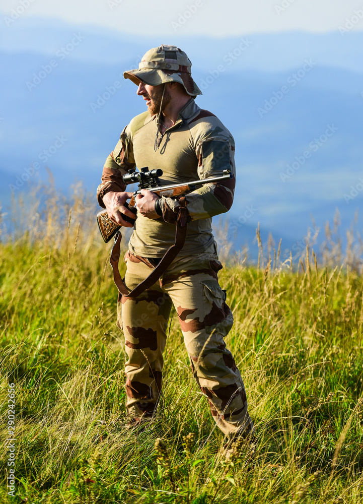 Army forces. Ready to shoot. Hunter hold rifle. Hunter mountains landscape background. Focus and concentration experienced hunter. Man military clothes with weapon. Brutal warrior. Rifle for hunting Army forces. Ready to shoot. Hunter hold rifle. Hunter mountains landscape background. Focus and concentration experienced hunter. Man military clothes with weapon. Brutal warrior. Rifle for hunting