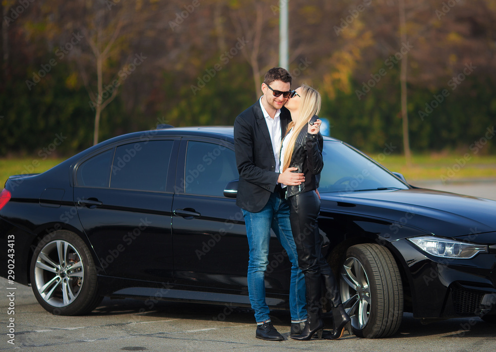 Happy couple buy new modern black car Happy couple buy new modern black car