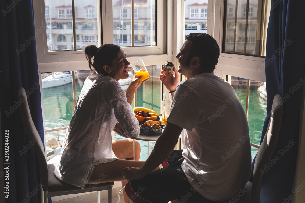 Happy young Couple Enjoying Breakfast .on the terrace at the marina. Relationship and lifestyle concept. - obrazy, fototapety, plakaty 