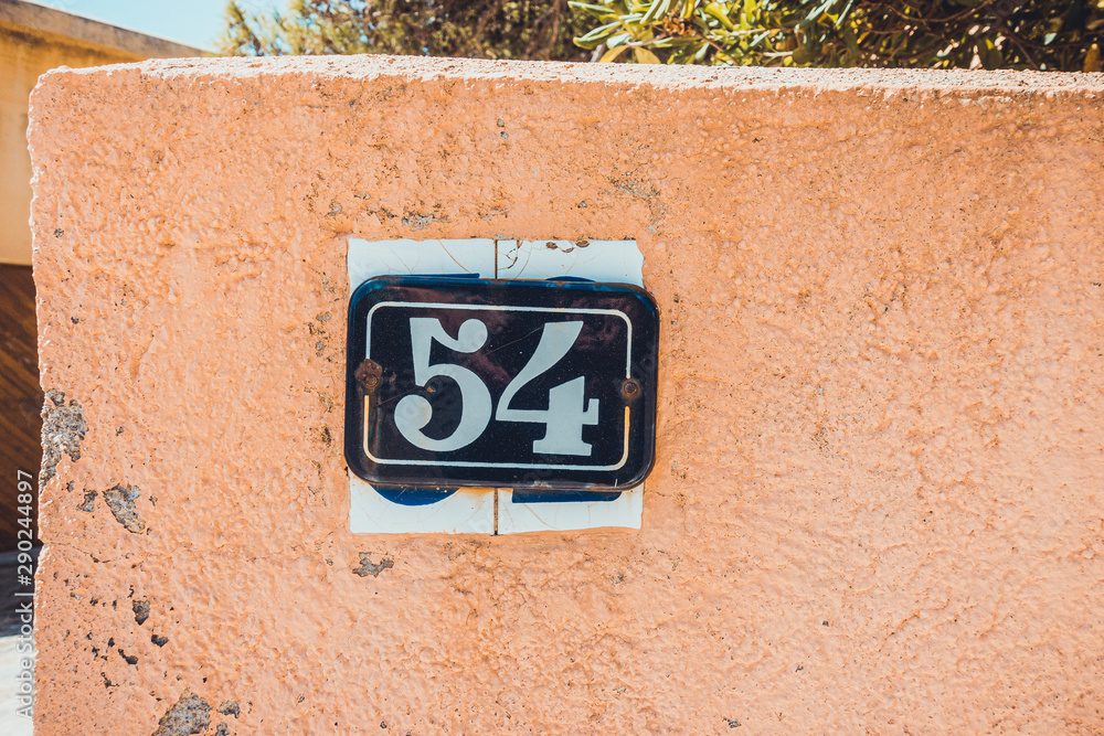 number 54 door sign with orange background