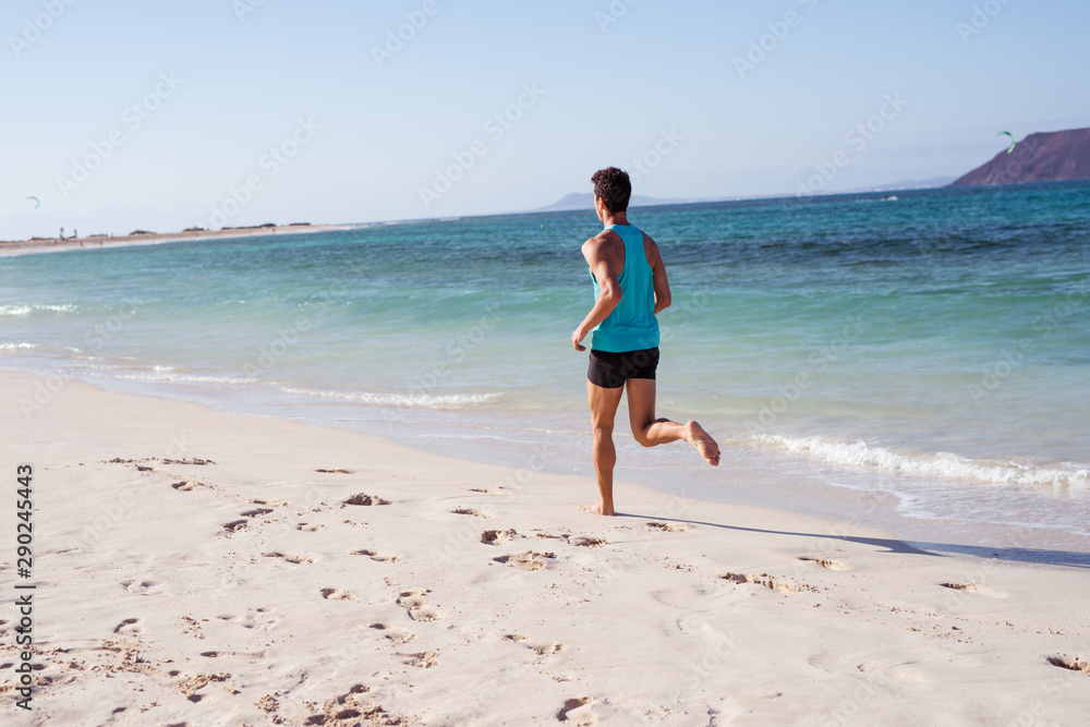 Rear view shot of a jogger on the beach