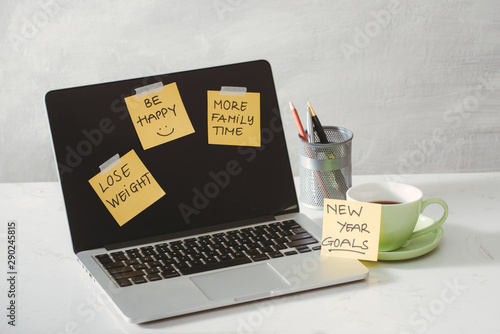 colored paper stickers with business strategy and laptop on tabletop