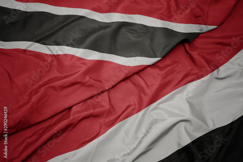 waving colorful flag of yemen and national flag of trinidad and tobago