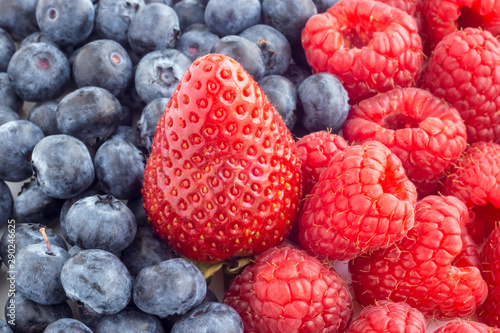 Ripe strawberries, blueberries and raspberries, background