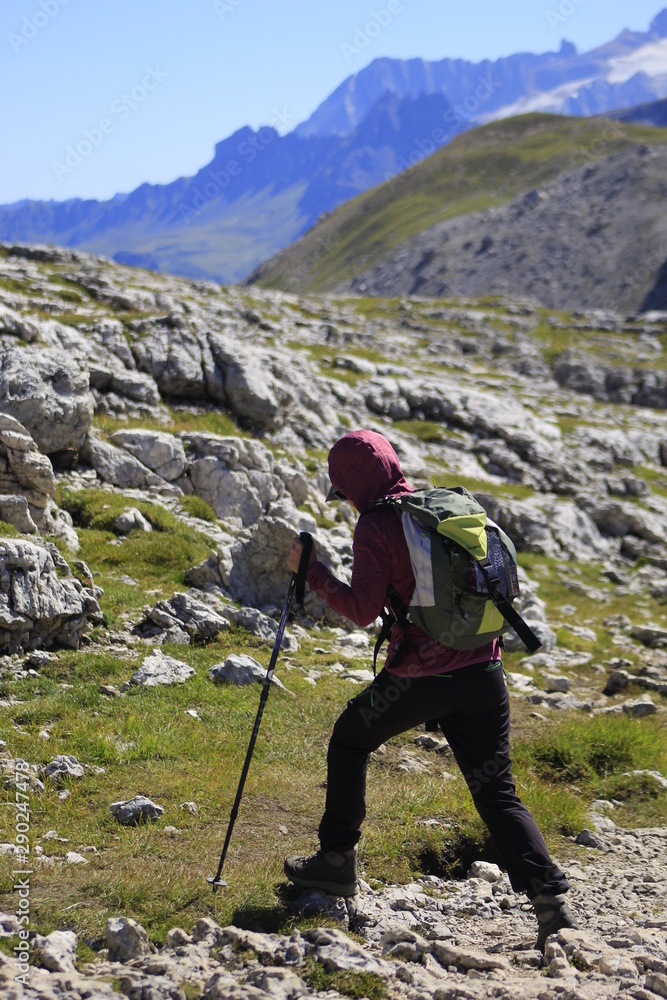 Persona fa trekking su rocce in montagna sulle Alpi Dolomiti
