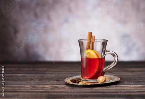 Christmas Mulled wine hot drink with spices on wooden background