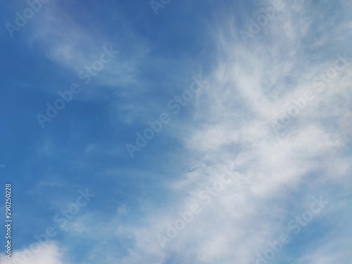 The blue sky with white clouds floating on space. 