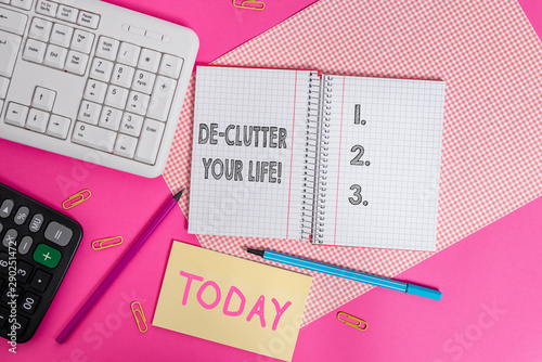 Writing note showing De Clutter Your Life. Business concept for remove unnecessary items from untidy or overcrowded places Writing equipments and computer stuffs placed above colored plain table