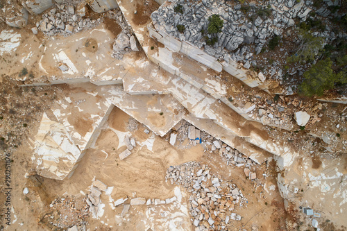 Marble quarry ledges. Terraces of cutted stone material. Aerial view. photo