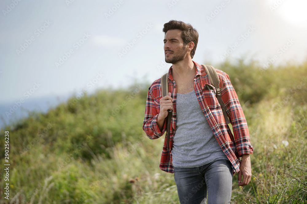 Man walking in country path by the sea