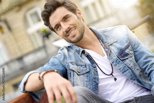 Trendy guy in town sitting on a public bench © goodluz