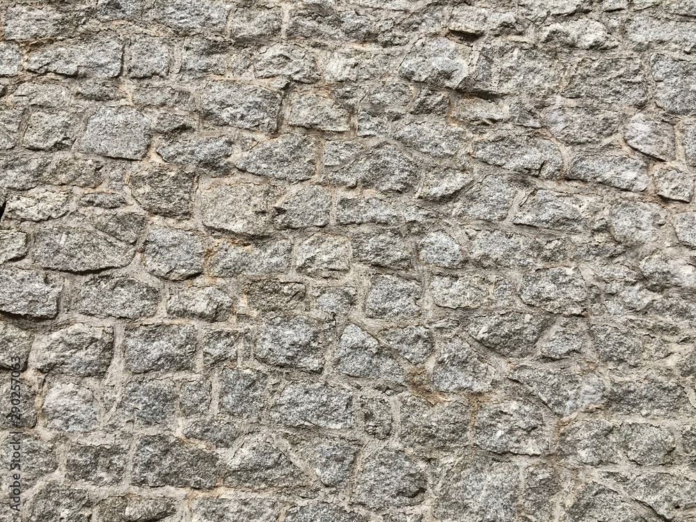 The ancient fortress wall is made of gray natural stone. The ancient fortress wall is made of gray natural stone.