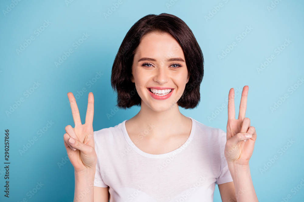 Close-up portrait of her she nice attractive lovely cheerful cheery feminine girl showing double v-sign enjoying leisure isolated on bright vivid shine vibrant blue turquoise color background Close-up portrait of her she nice attractive lovely cheerful cheery feminine girl showing double v-sign enjoying leisure isolated on bright vivid shine vibrant blue turquoise color background