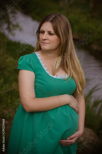  portrait of a pregnant young woman in dress in the garden © Ксения Куприянова