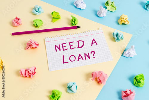 Text sign showing Need A Loanquestion. Business photo text offering a money for demonstratingal or business finances Colored crumpled papers empty reminder blue yellow background clothespin © Artur